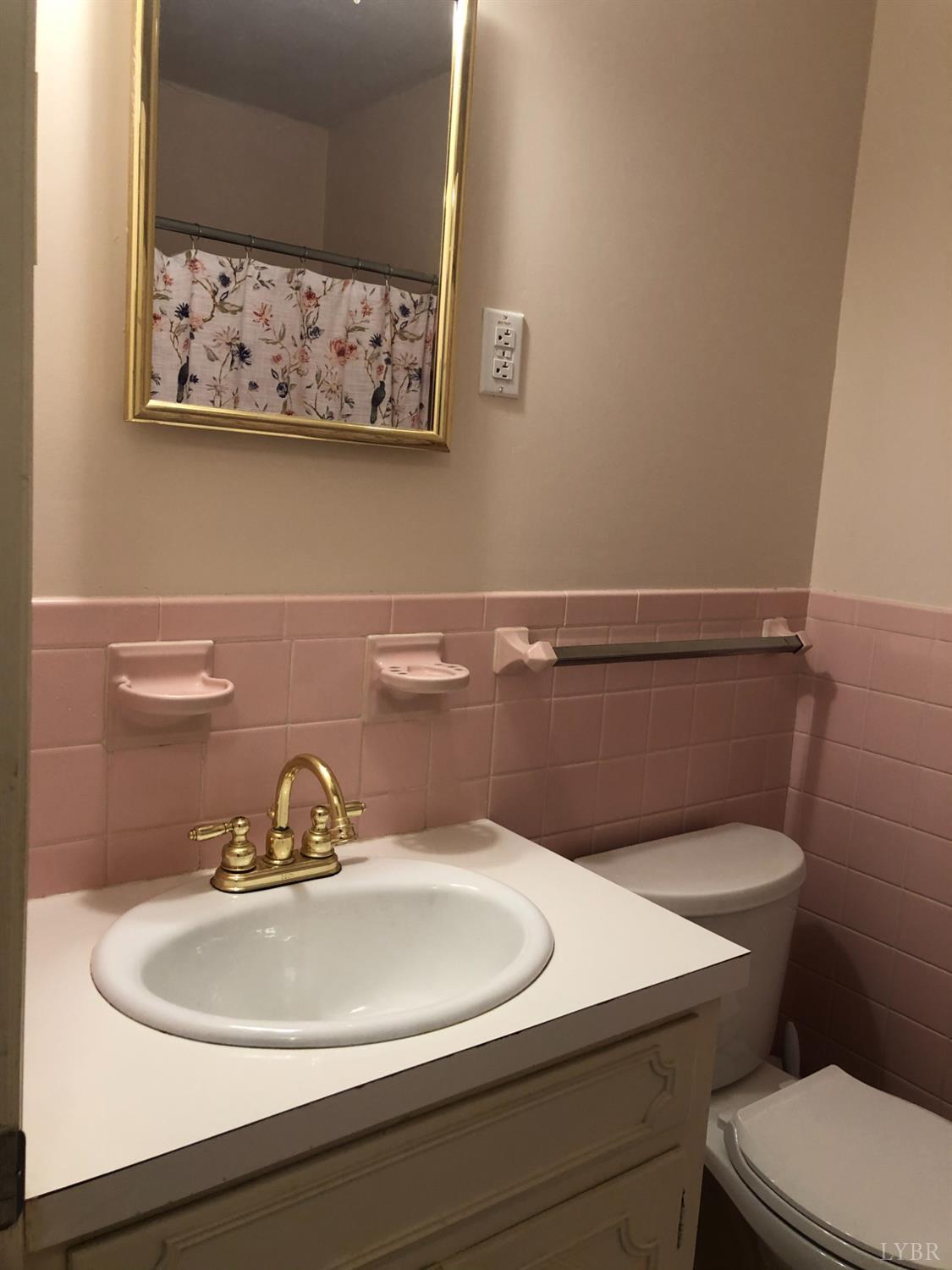 336 North Main Street Amherst, VA 24521 - Photo 27 of 60 a bathroom with a toilet sink and mirror