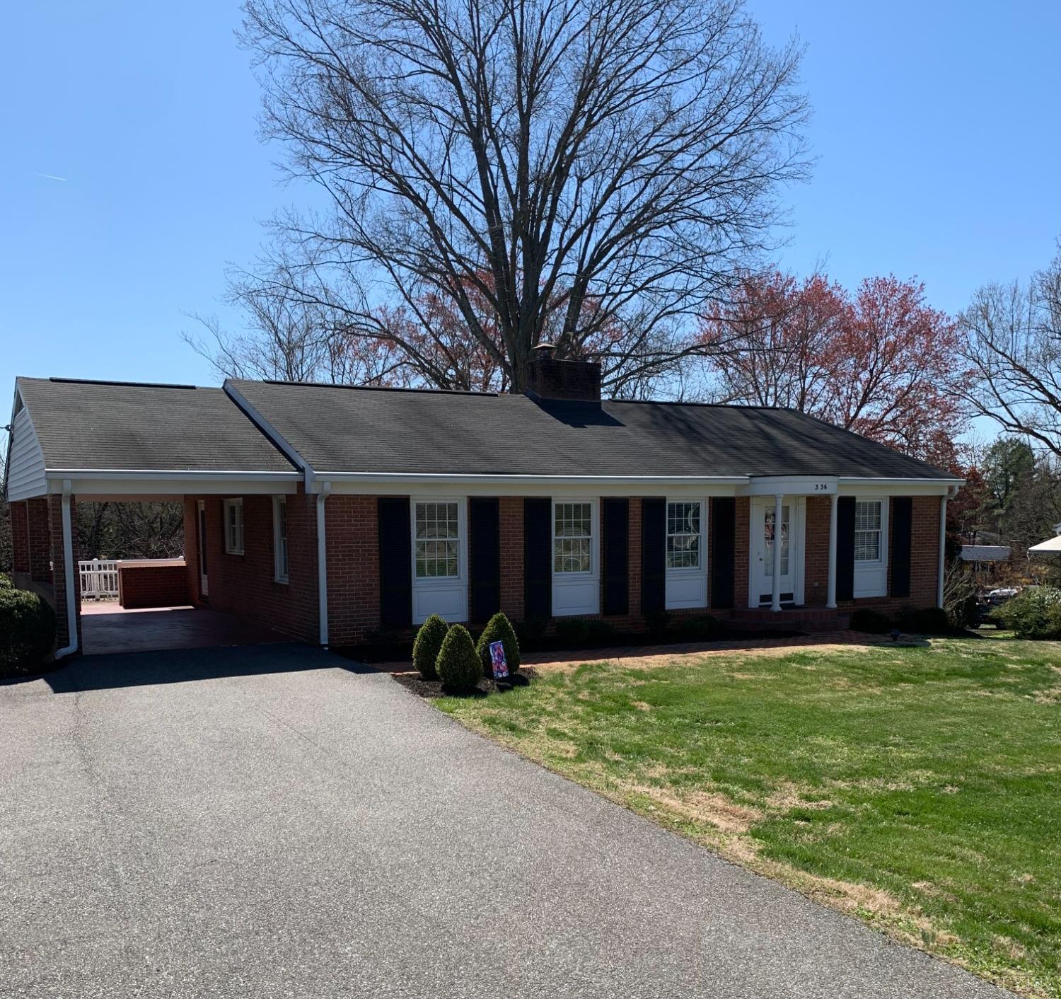 336 North Main Street Amherst, VA 24521 - Photo 3 of 60 a front view of a house with a yard and garage