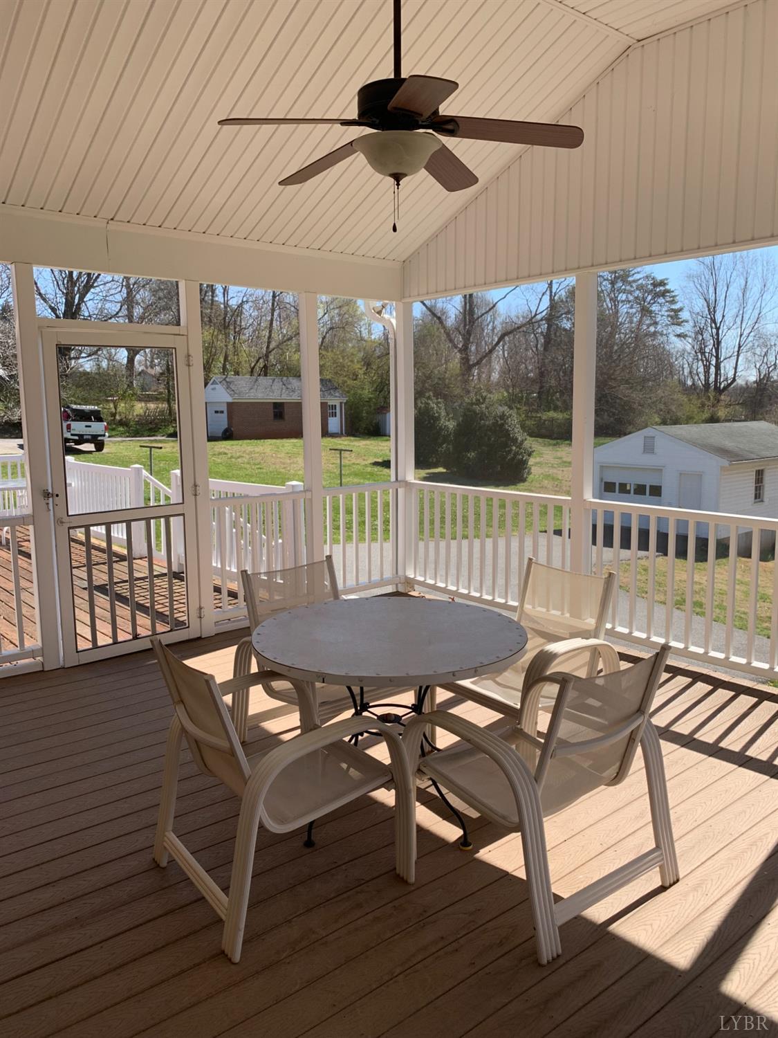 336 North Main Street Amherst, VA 24521 - Photo 35 of 60 a view of a patio with a table chairs and wooden floor