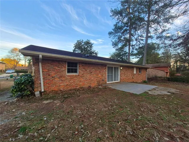 a front view of house with yard and trees