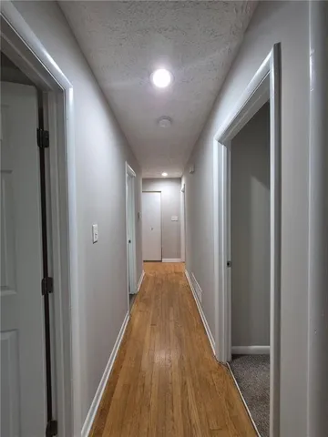 a view of hallway with wooden floor