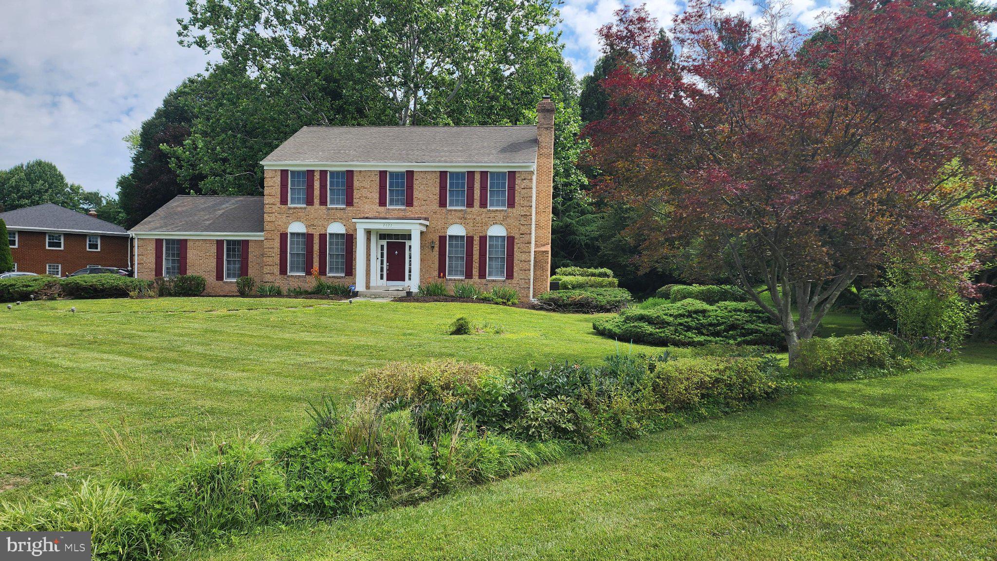 2625 McKenzie Road Ellicott City, MD 21042 - Photo 5 of 35 Charming brick home with lush greenery.