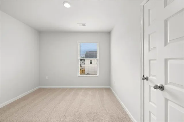 a view of a bathroom from the hallway with toilet