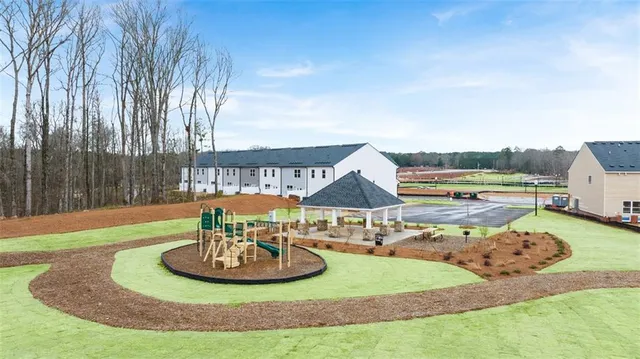 a view of a house with backyard and a slide