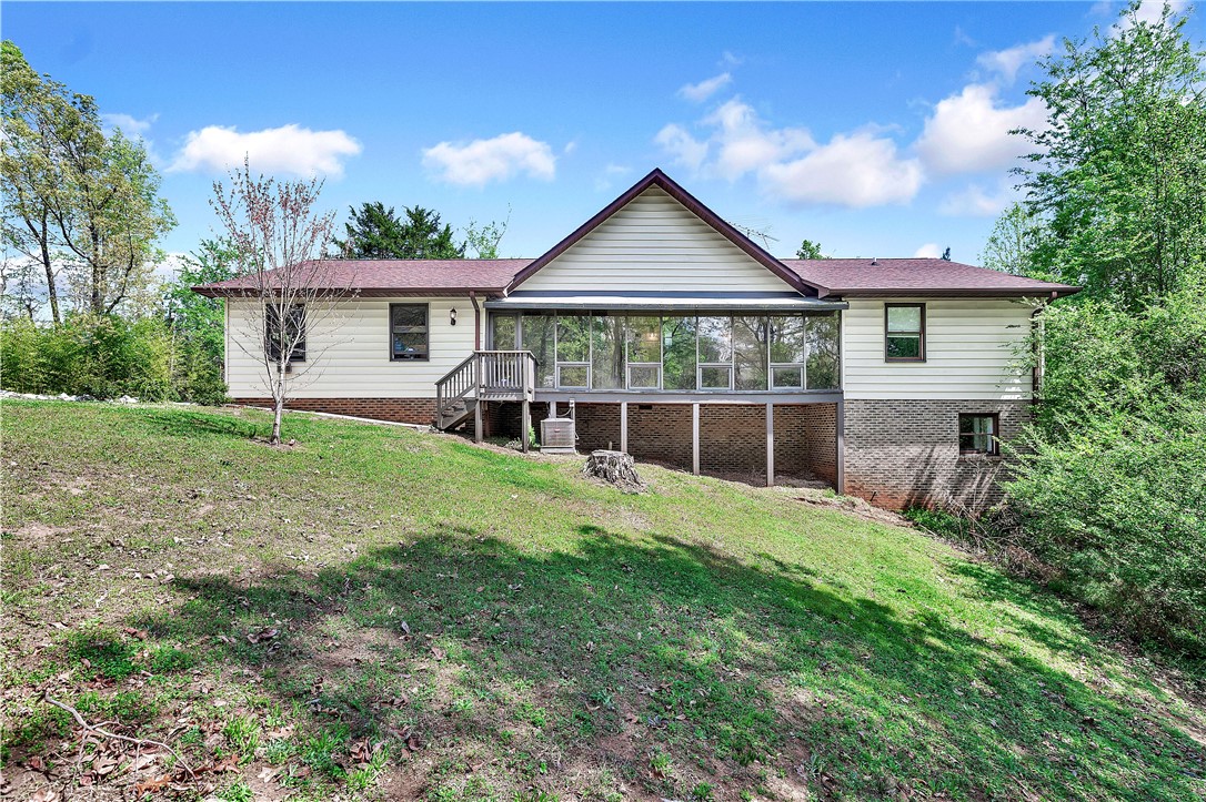 This charming home features a lovely screened porch, perfect for enjoying peaceful moments outdoors.