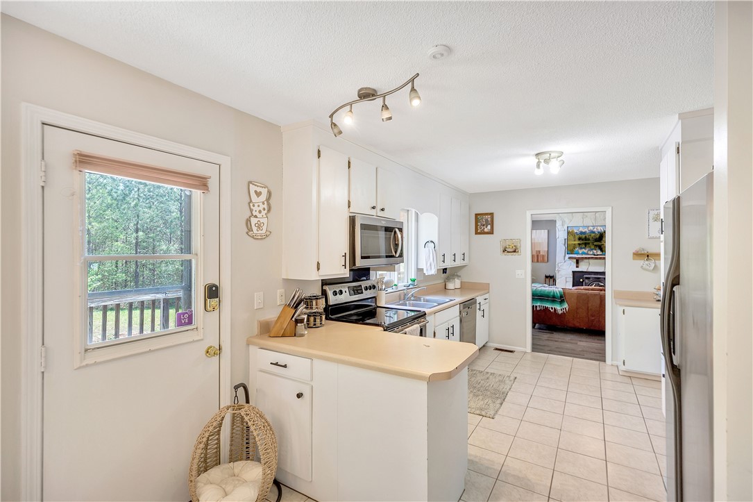 102 Rockingham Road Seneca, SC 29672 - Photo 11 of 39 This bright kitchen offers a functional layout with direct access to outdoor space.