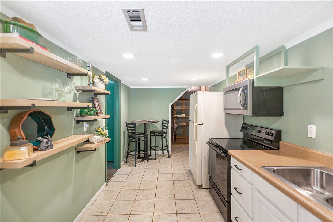 102 Rockingham Road Seneca, SC 29672 - Photo 24 of 39 This cozy kitchen features practical appliances and charming open shelving.