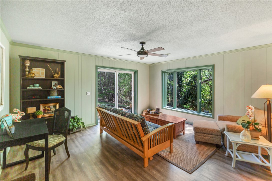 102 Rockingham Road Seneca, SC 29672 - Photo 30 of 39 This inviting room offers serene wooded views through expansive windows and a sliding glass door.