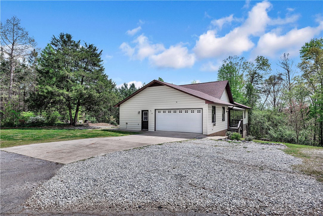 102 Rockingham Road Seneca, SC 29672 - Photo 39 of 39 This charming home offers a convenient garage and a welcoming entrance surrounded by nature's beauty.