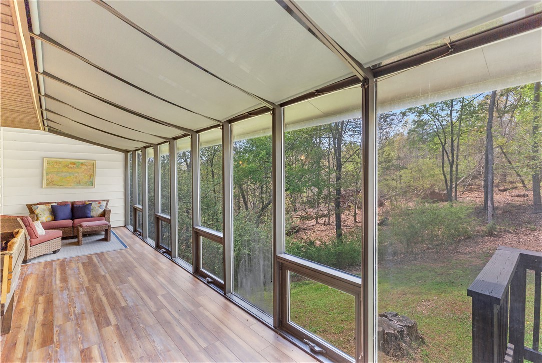 102 Rockingham Road Seneca, SC 29672 - Photo 4 of 39 This sunroom offers panoramic views, connecting indoors with the natural beauty outside.