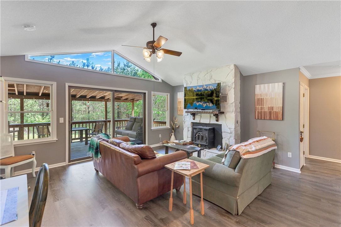 102 Rockingham Road Seneca, SC 29672 - Photo 6 of 39 This living room features expansive windows, a cozy fireplace, and direct access to an outdoor deck.