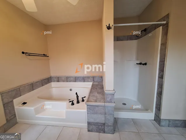 a bathroom with a bathtub and shower