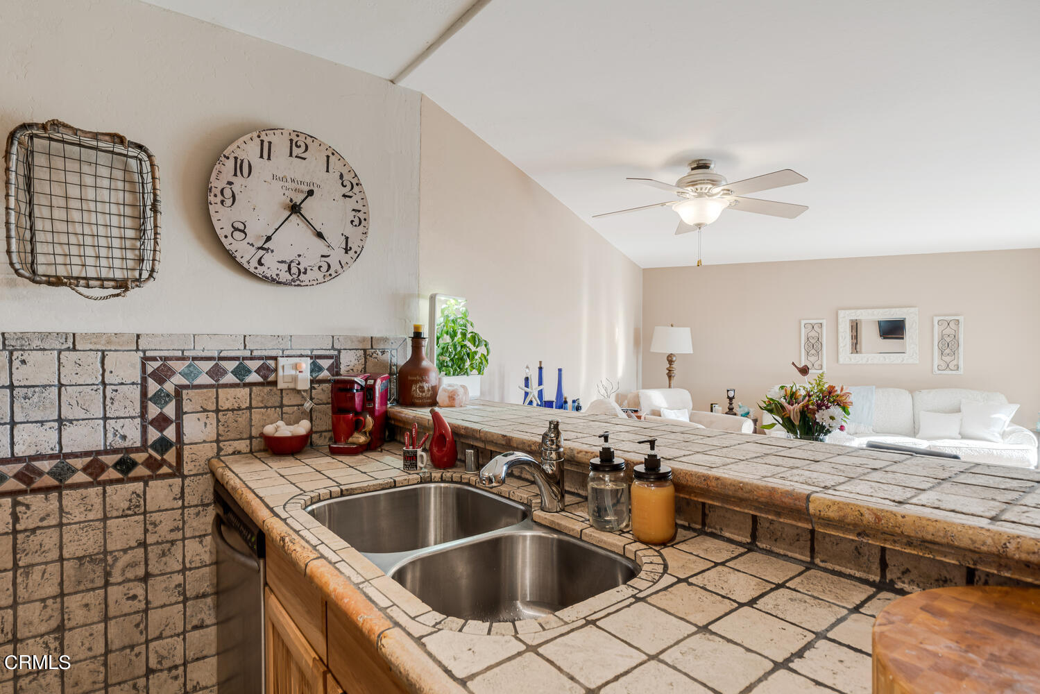 2901 Peninsula Road, Unit 134 Oxnard, CA 93035 - Photo 8 of 31 a kitchen with a sink and a clock on the wall