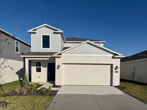 a front view of a house with garage