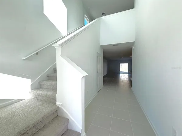 a view of a hallway view with staircase