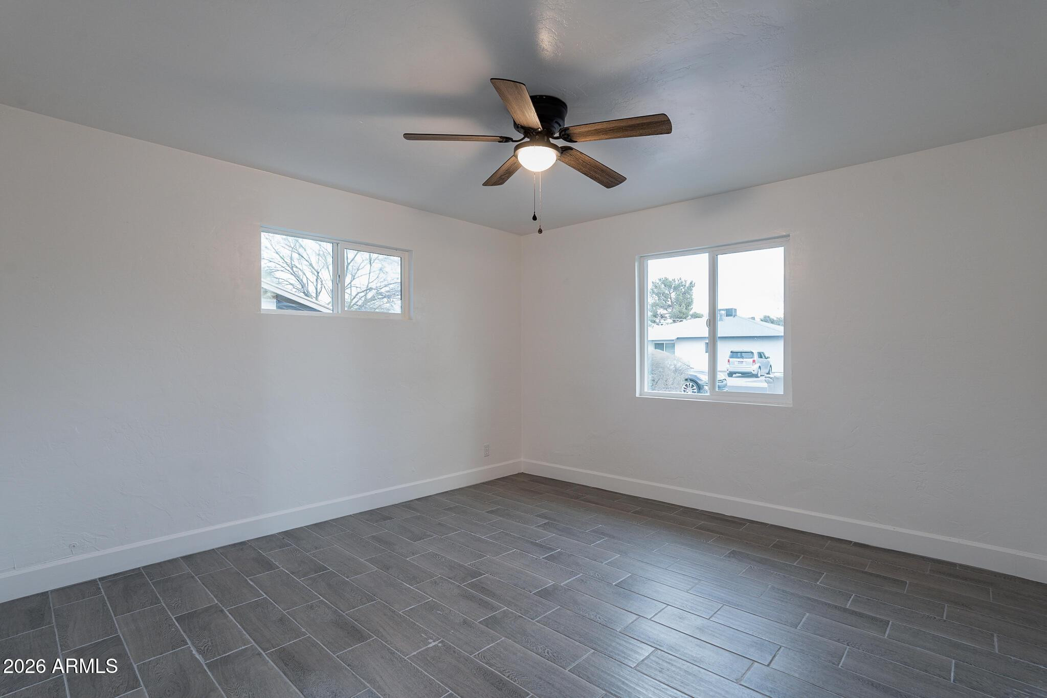 536 West 18th Street Tempe, AZ 85281 - Photo 14 of 39 an empty room with wooden floor ceiling fan and windows