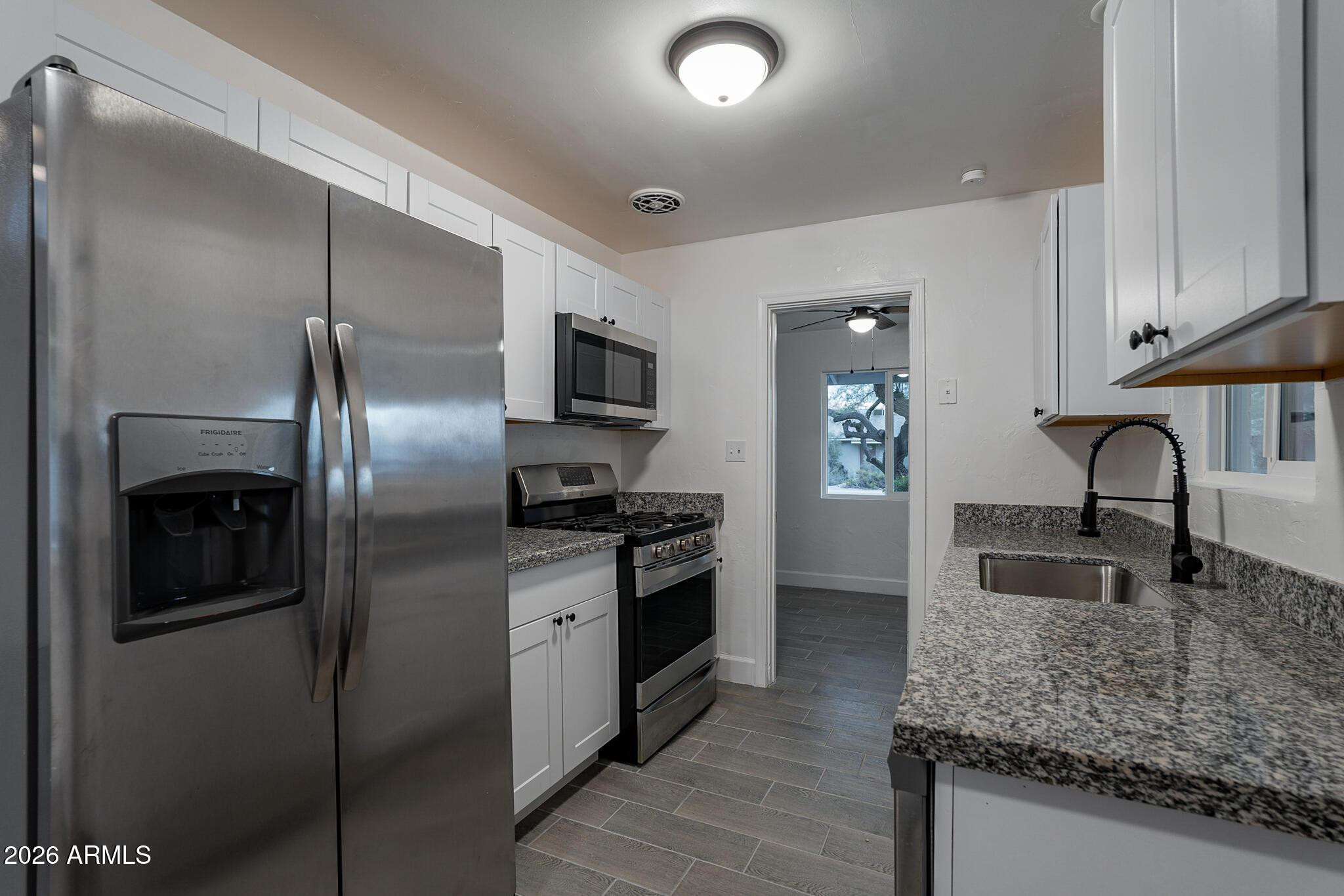 536 West 18th Street Tempe, AZ 85281 - Photo 20 of 39 a kitchen with stainless steel appliances granite countertop a sink stove and refrigerator