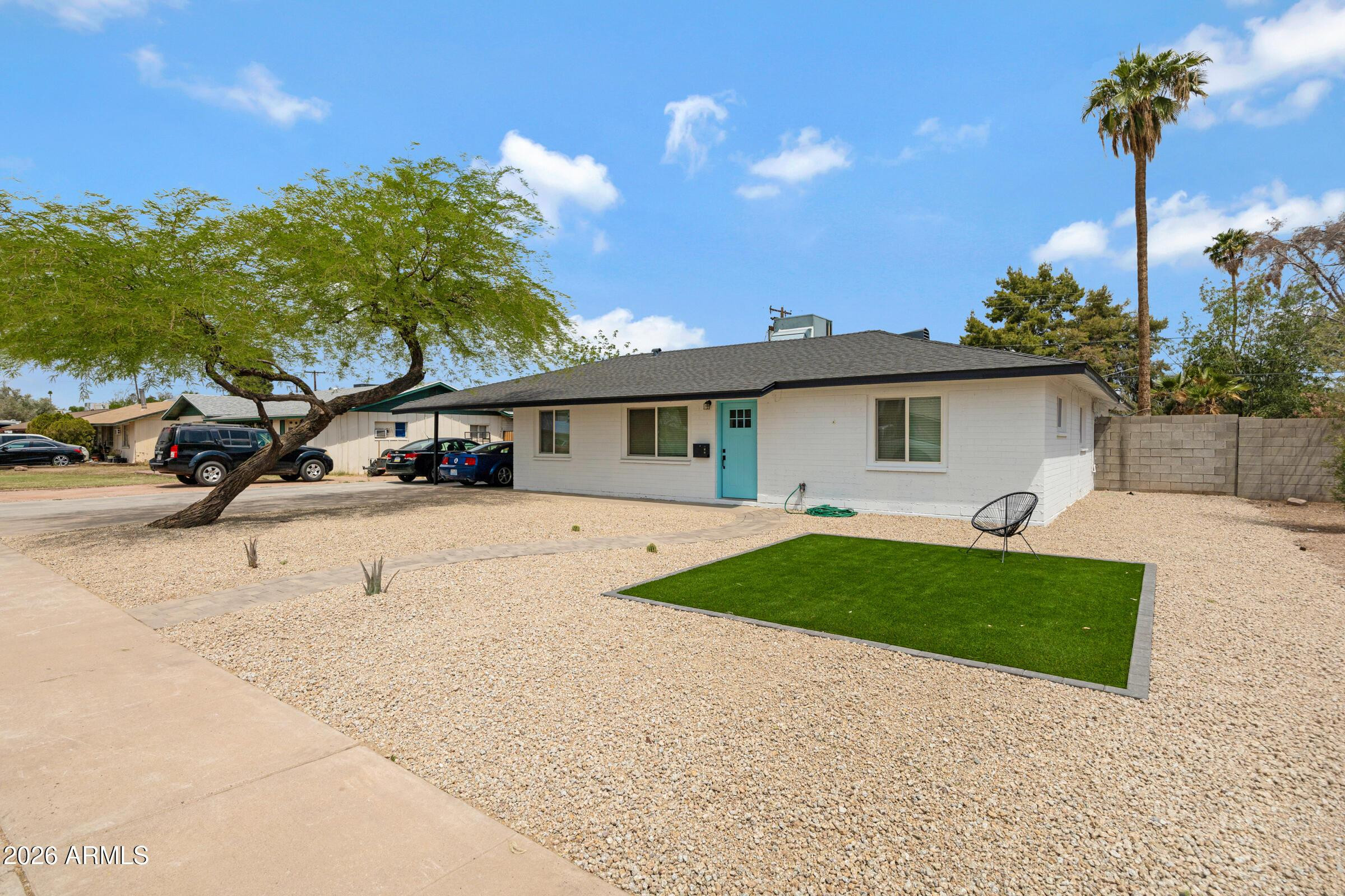 536 West 18th Street Tempe, AZ 85281 - Photo 2 of 39 a front view of a house with a yard and garage