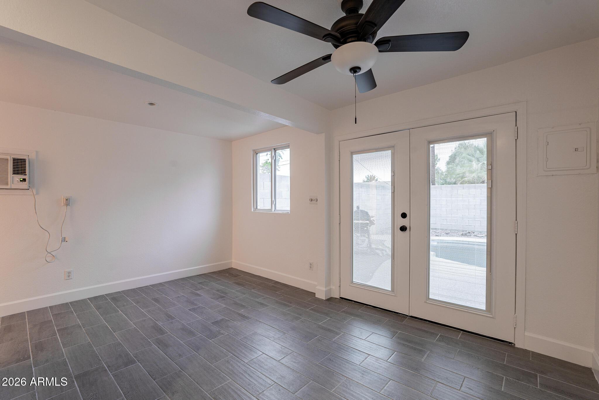 536 West 18th Street Tempe, AZ 85281 - Photo 28 of 39 a view of an empty room with a window and wooden floor