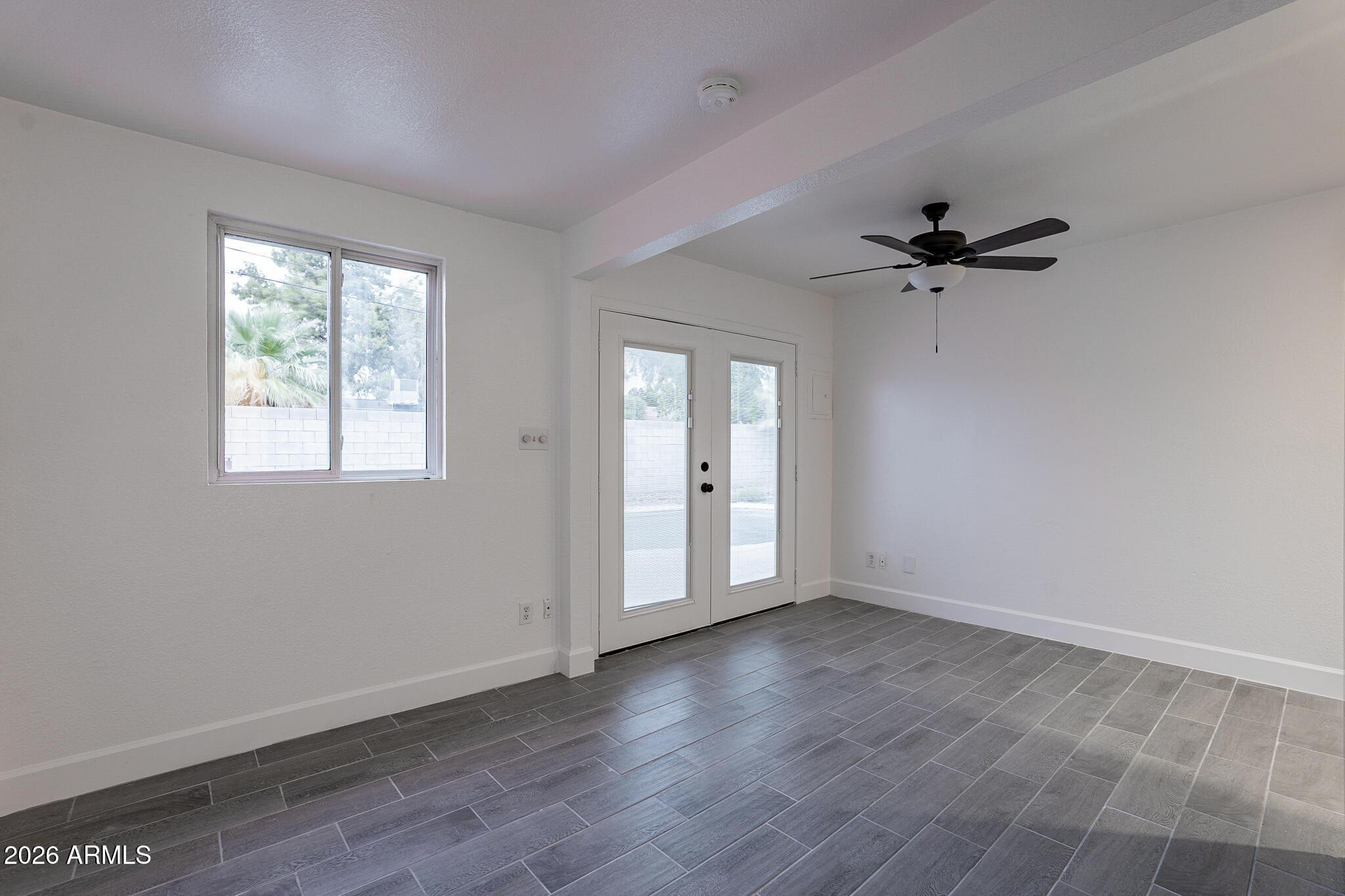 536 West 18th Street Tempe, AZ 85281 - Photo 29 of 39 a view of an empty room with a window and wooden floor