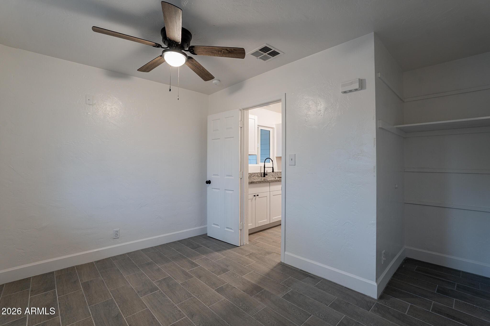 536 West 18th Street Tempe, AZ 85281 - Photo 32 of 39 an empty room with wooden floor ceiling fan and windows