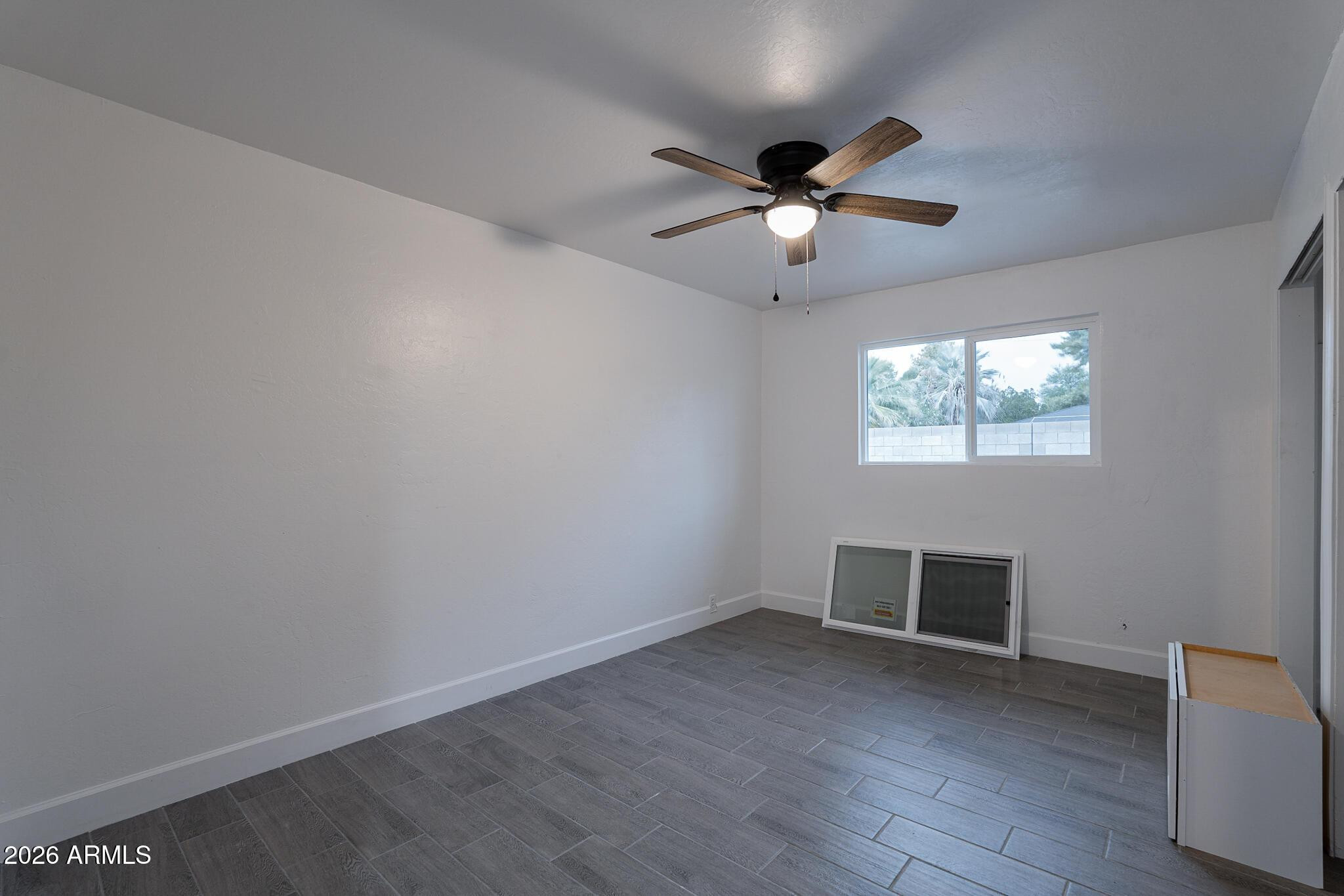 536 West 18th Street Tempe, AZ 85281 - Photo 33 of 39 an empty room with wooden floor fan and windows