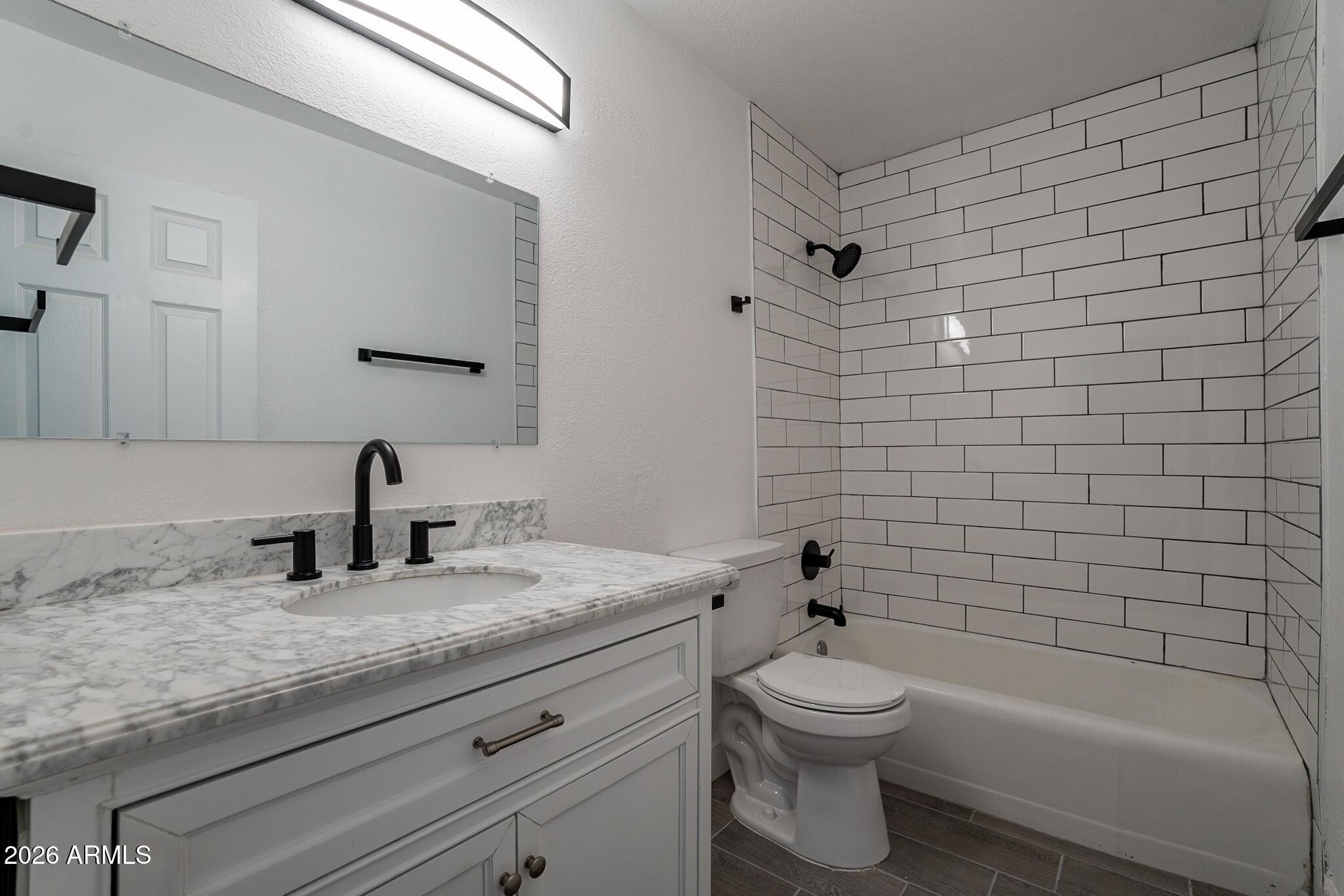536 West 18th Street Tempe, AZ 85281 - Photo 34 of 39 a bathroom with a granite countertop toilet a sink and bathtub