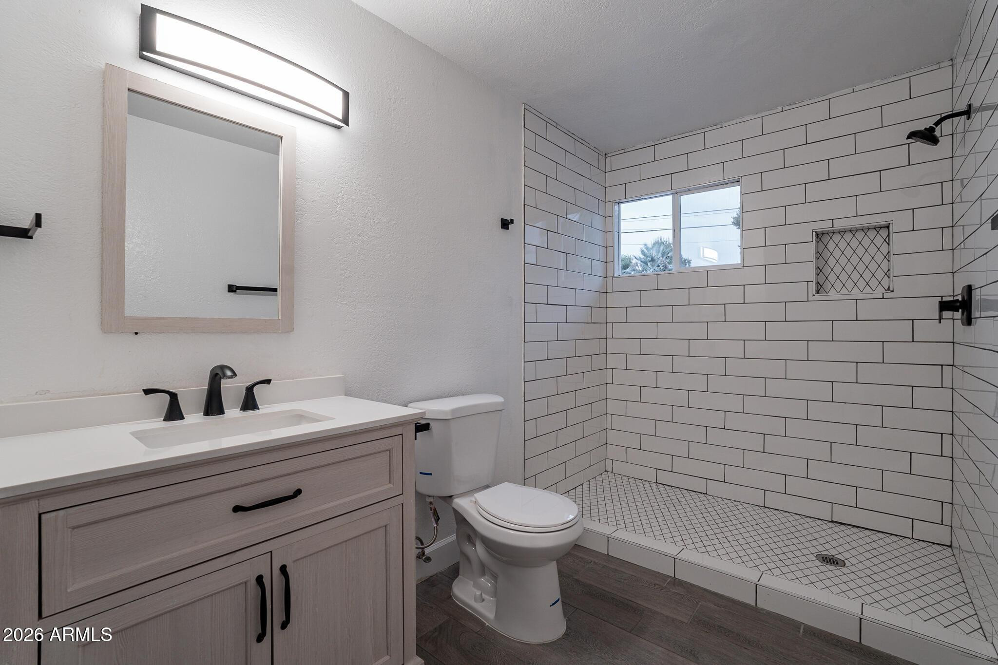 536 West 18th Street Tempe, AZ 85281 - Photo 35 of 39 a bathroom with a toilet sink vanity and mirror