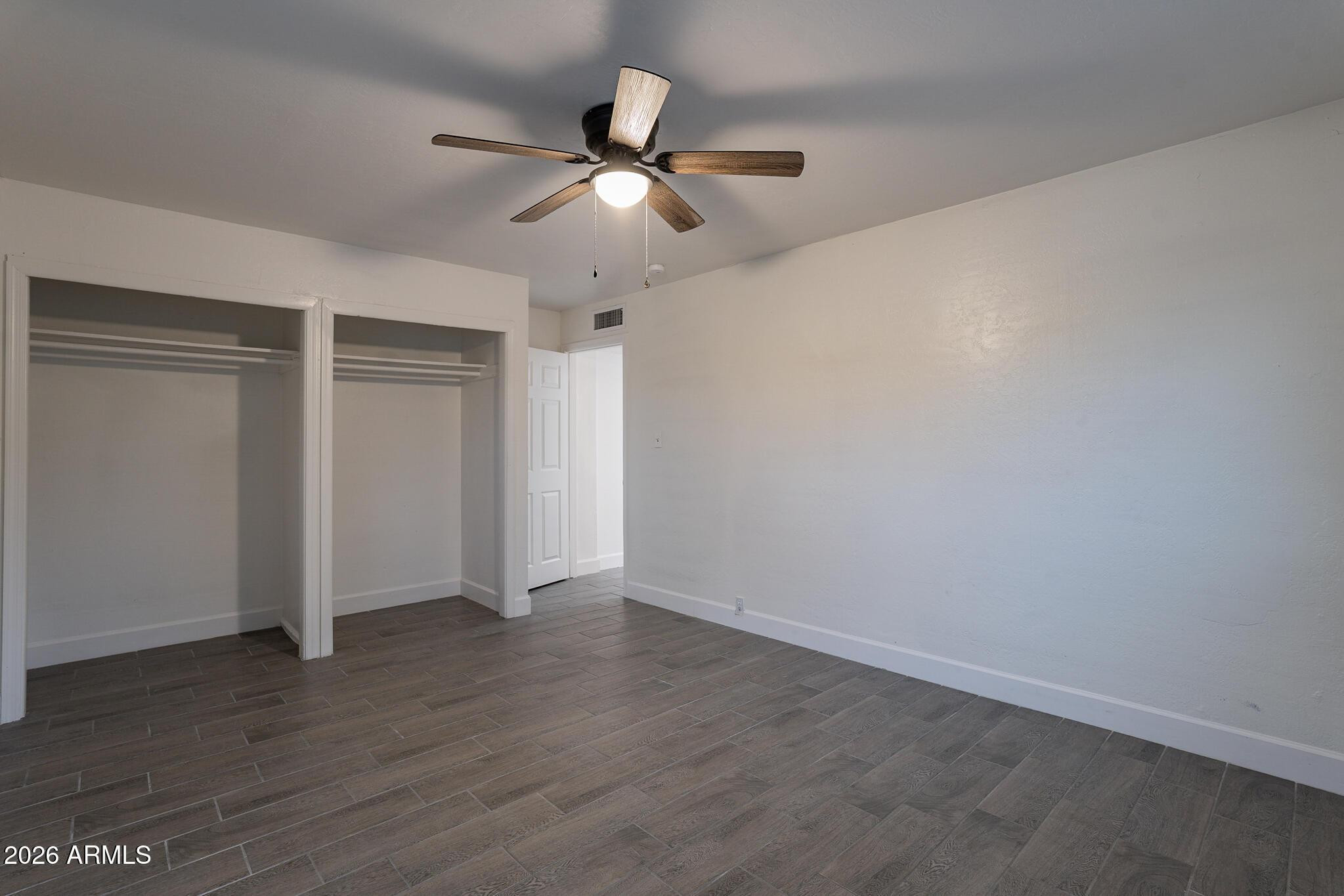 536 West 18th Street Tempe, AZ 85281 - Photo 37 of 39 an empty room with wooden floor fan and windows