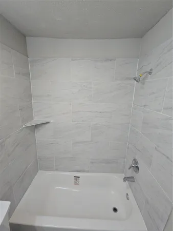 a bathroom with a shower and a bathtub