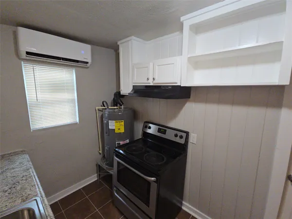 a kitchen with a stove and a cabinet