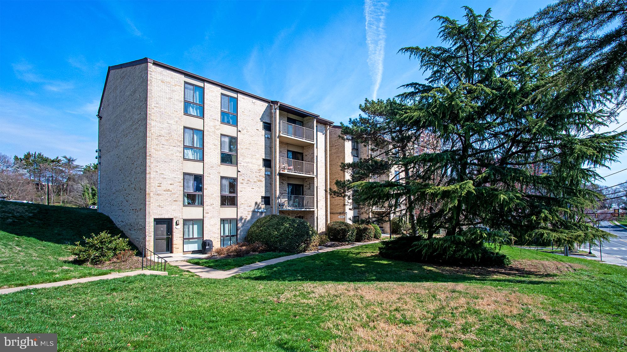 a front view of building with yard