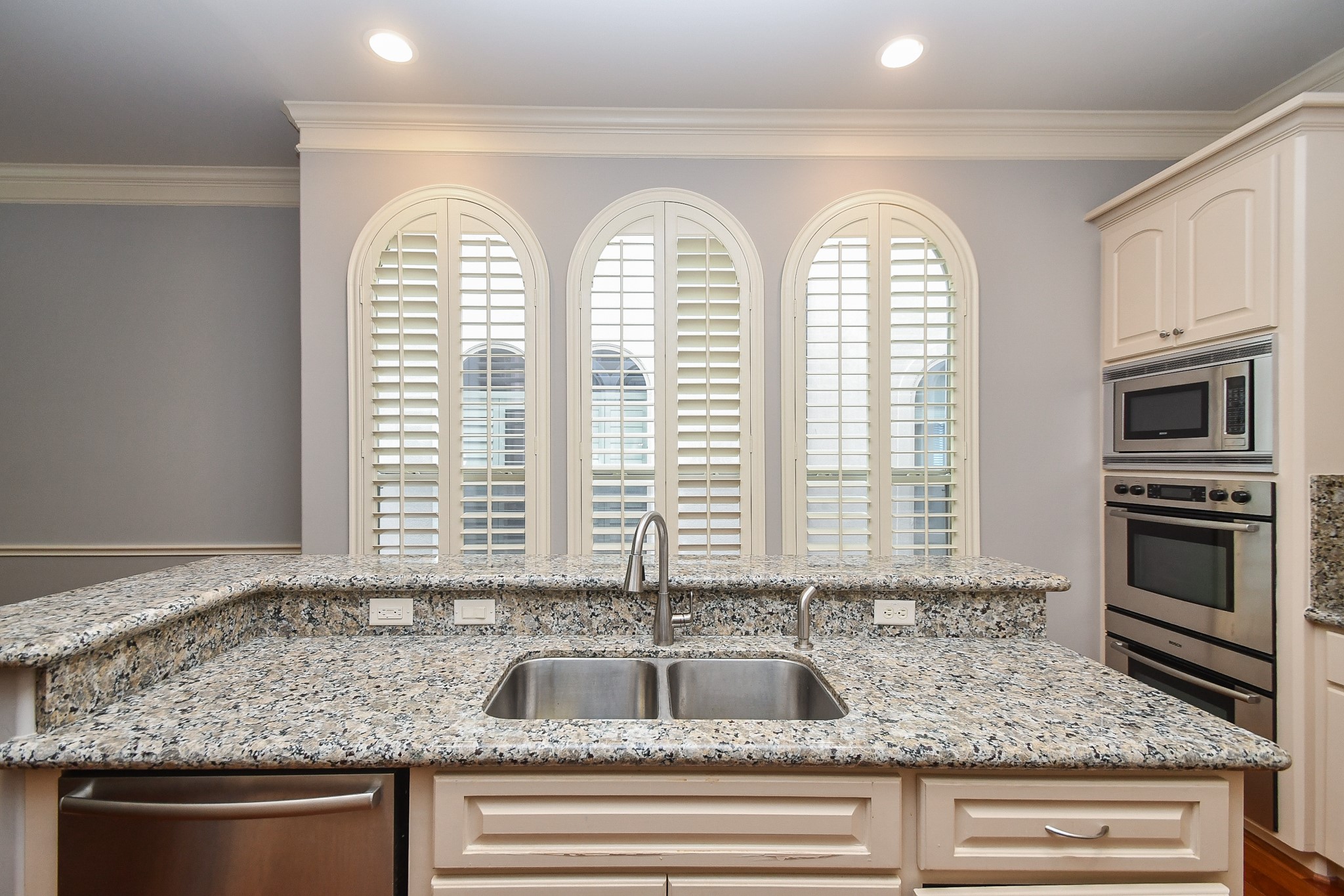 717 Welch Street Houston, TX 77006 - Photo 15 of 32 a kitchen with granite countertop a sink and microwave