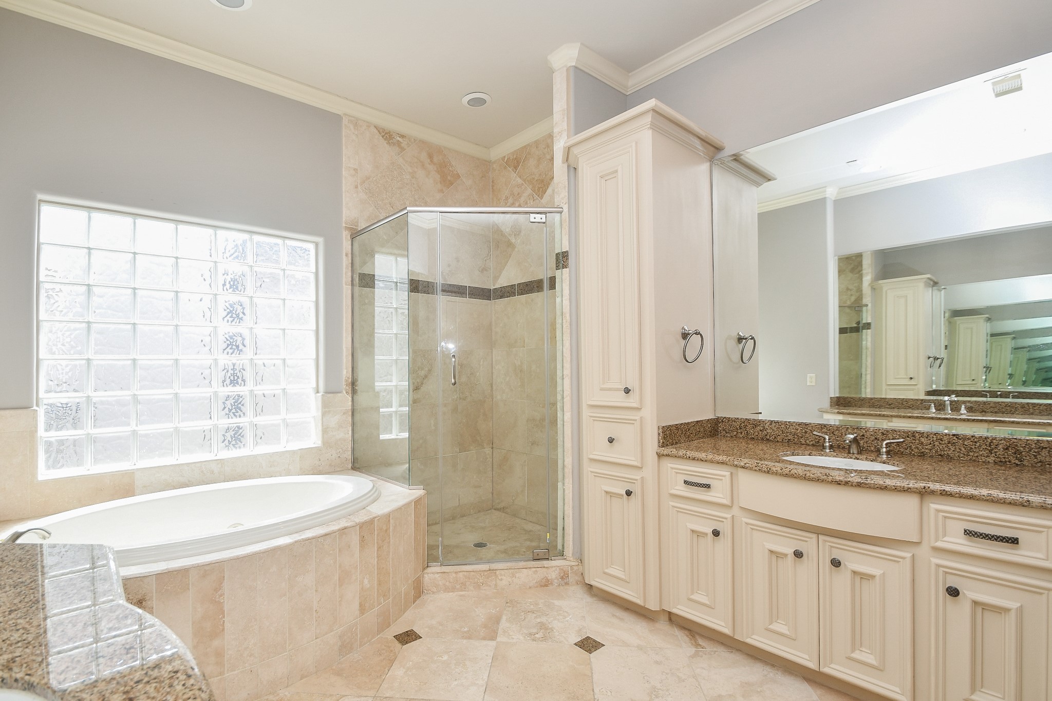 717 Welch Street Houston, TX 77006 - Photo 21 of 32 a spacious bathroom with a granite countertop tub shower sink and mirror