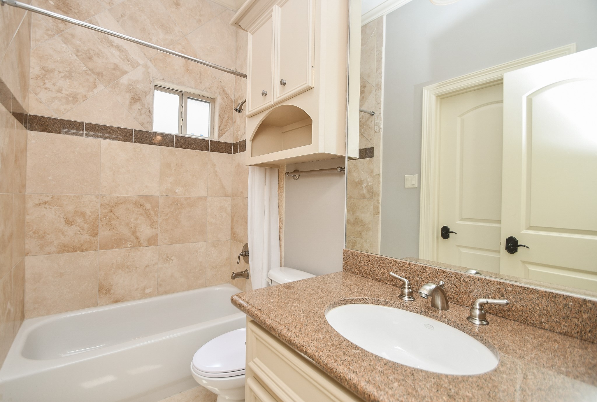 717 Welch Street Houston, TX 77006 - Photo 29 of 32 a bathroom with a granite countertop sink mirror toilet and bathtub