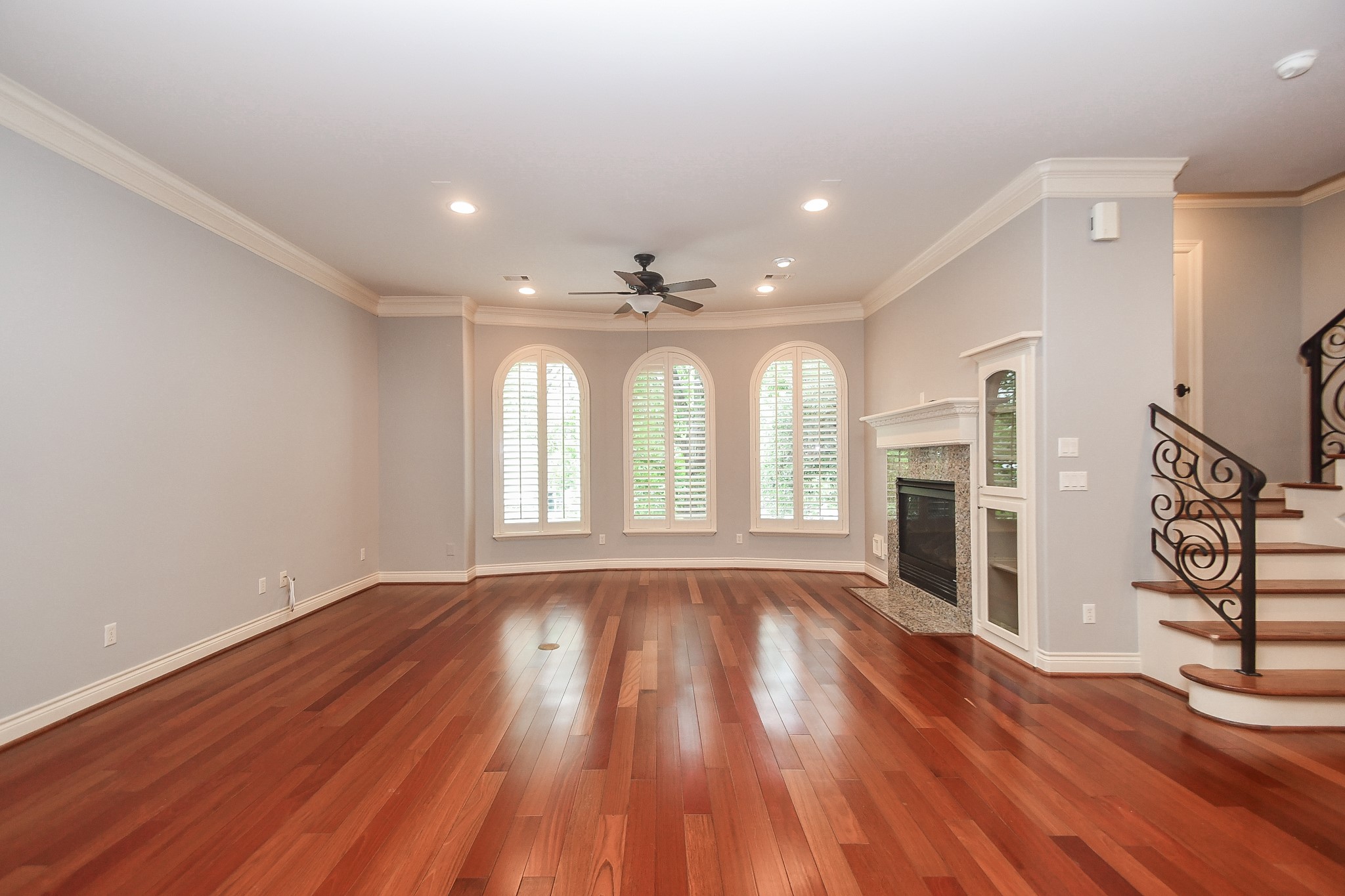 717 Welch Street Houston, TX 77006 - Photo 8 of 32 a view of an empty room with wooden floor and a window