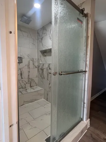 a bathroom with a glass shower door