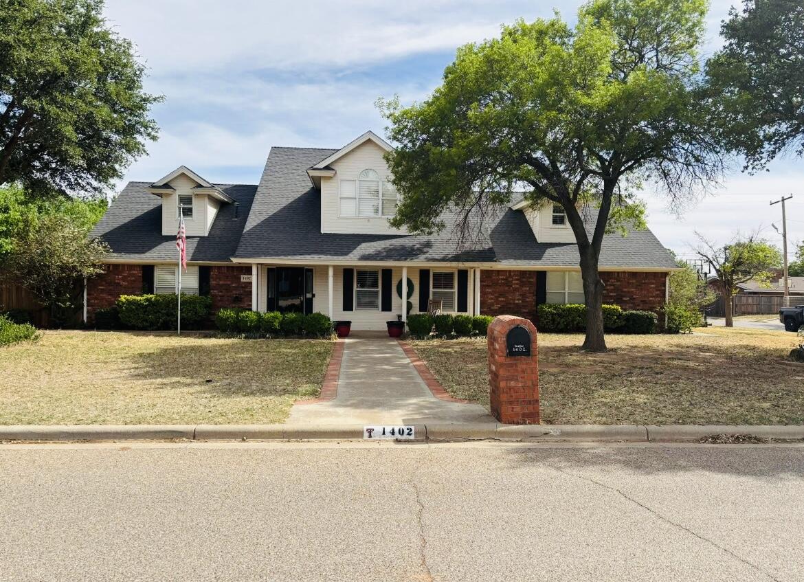 1402 9th Street Shallowater, TX 79363 - Photo 1 of 49 a front view of a house with a yard