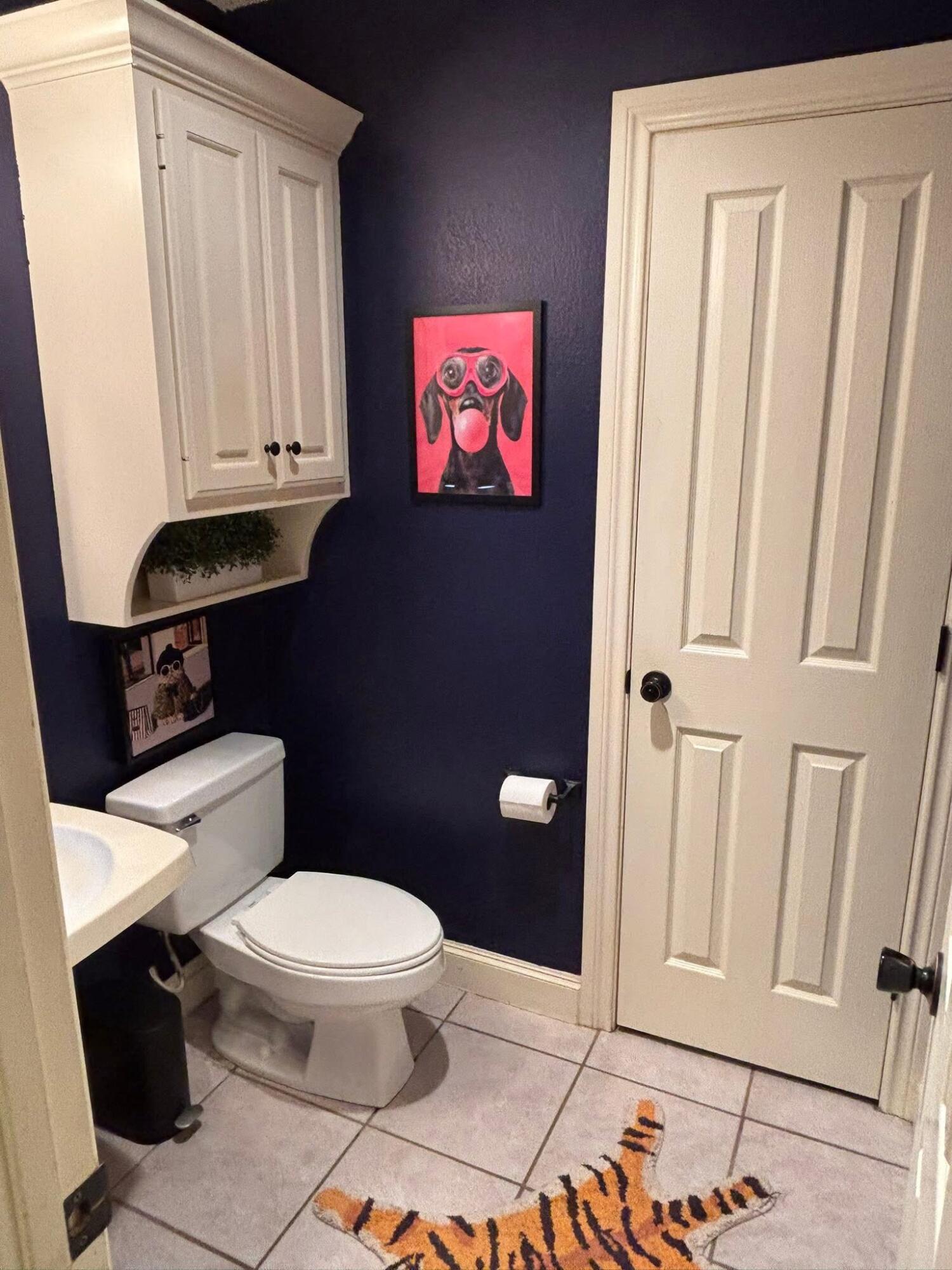 1402 9th Street Shallowater, TX 79363 - Photo 11 of 49 a bathroom with a toilet and a shower curtain
