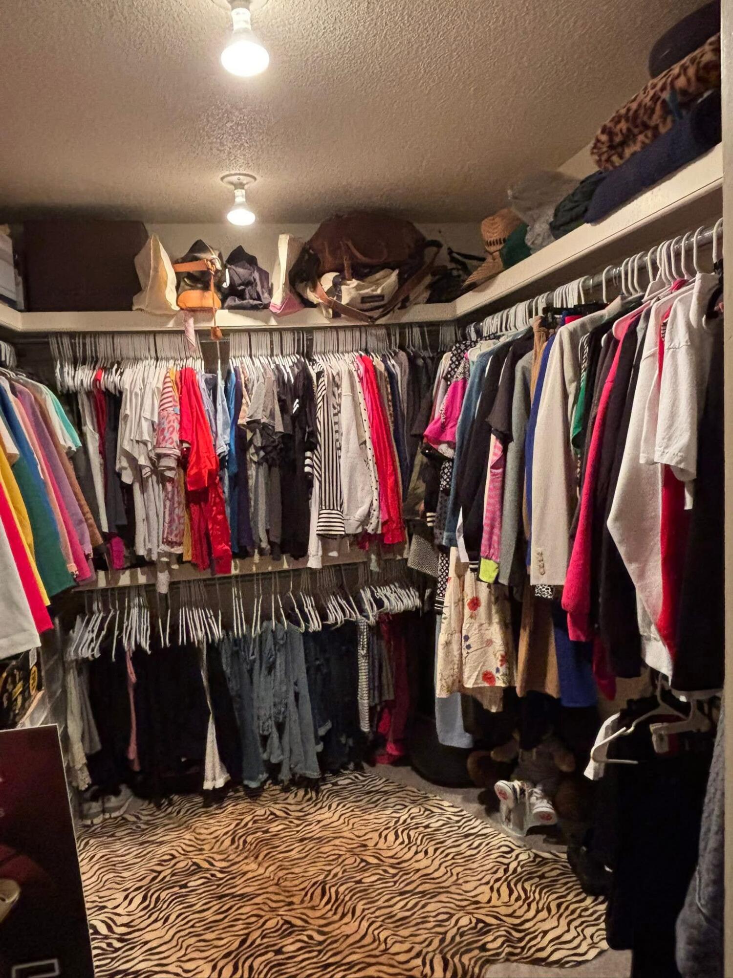 1402 9th Street Shallowater, TX 79363 - Photo 14 of 49 a view of walk in closet with clothes