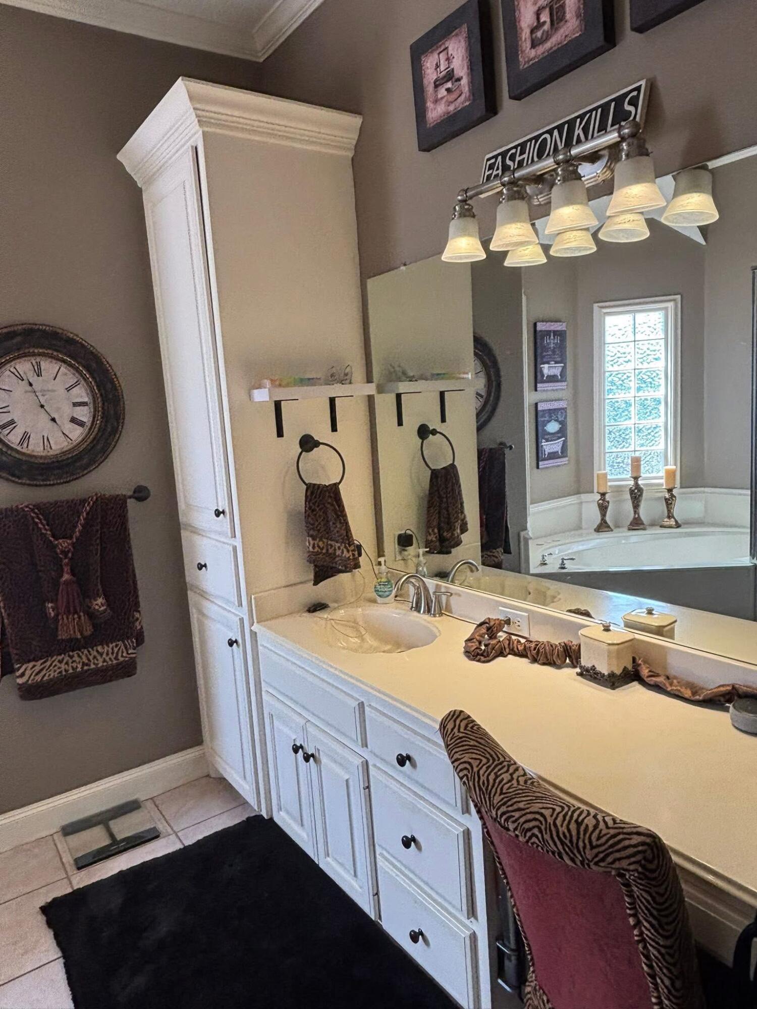 1402 9th Street Shallowater, TX 79363 - Photo 15 of 49 a spacious bathroom with a granite countertop sink and a mirror