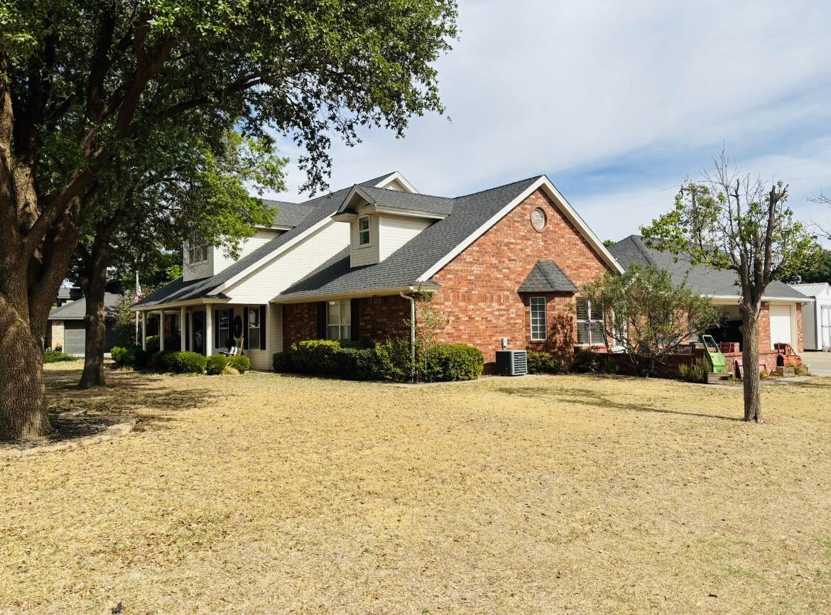 1402 9th Street Shallowater, TX 79363 - Photo 2 of 49 a front view of a house with a yard covered with snow