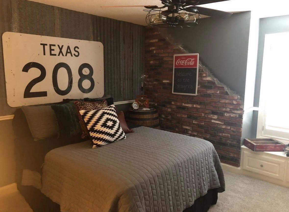 1402 9th Street Shallowater, TX 79363 - Photo 31 of 49 a bedroom with a bed and a chandelier