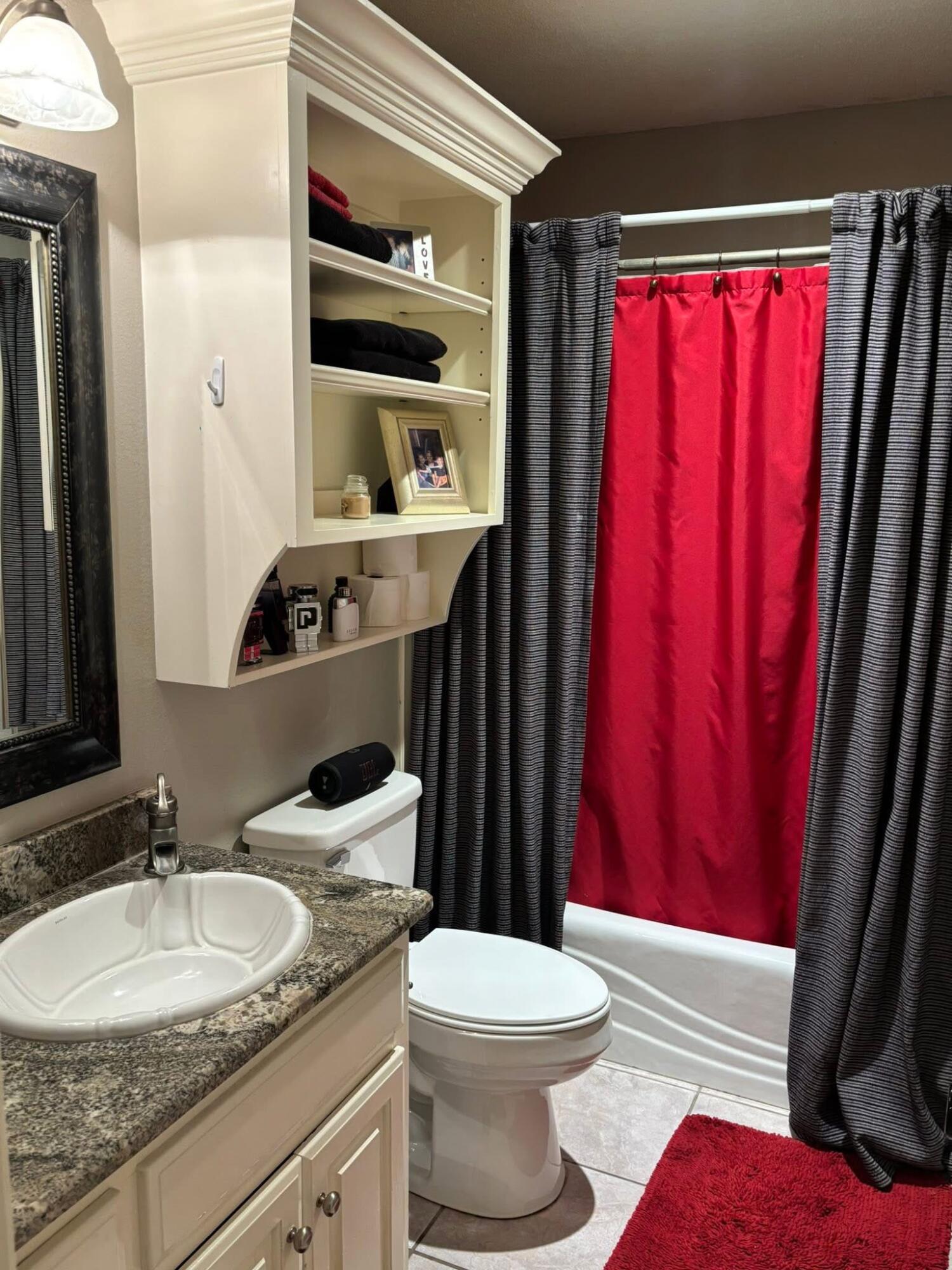 1402 9th Street Shallowater, TX 79363 - Photo 33 of 49 a bathroom with a granite countertop toilet sink and mirror