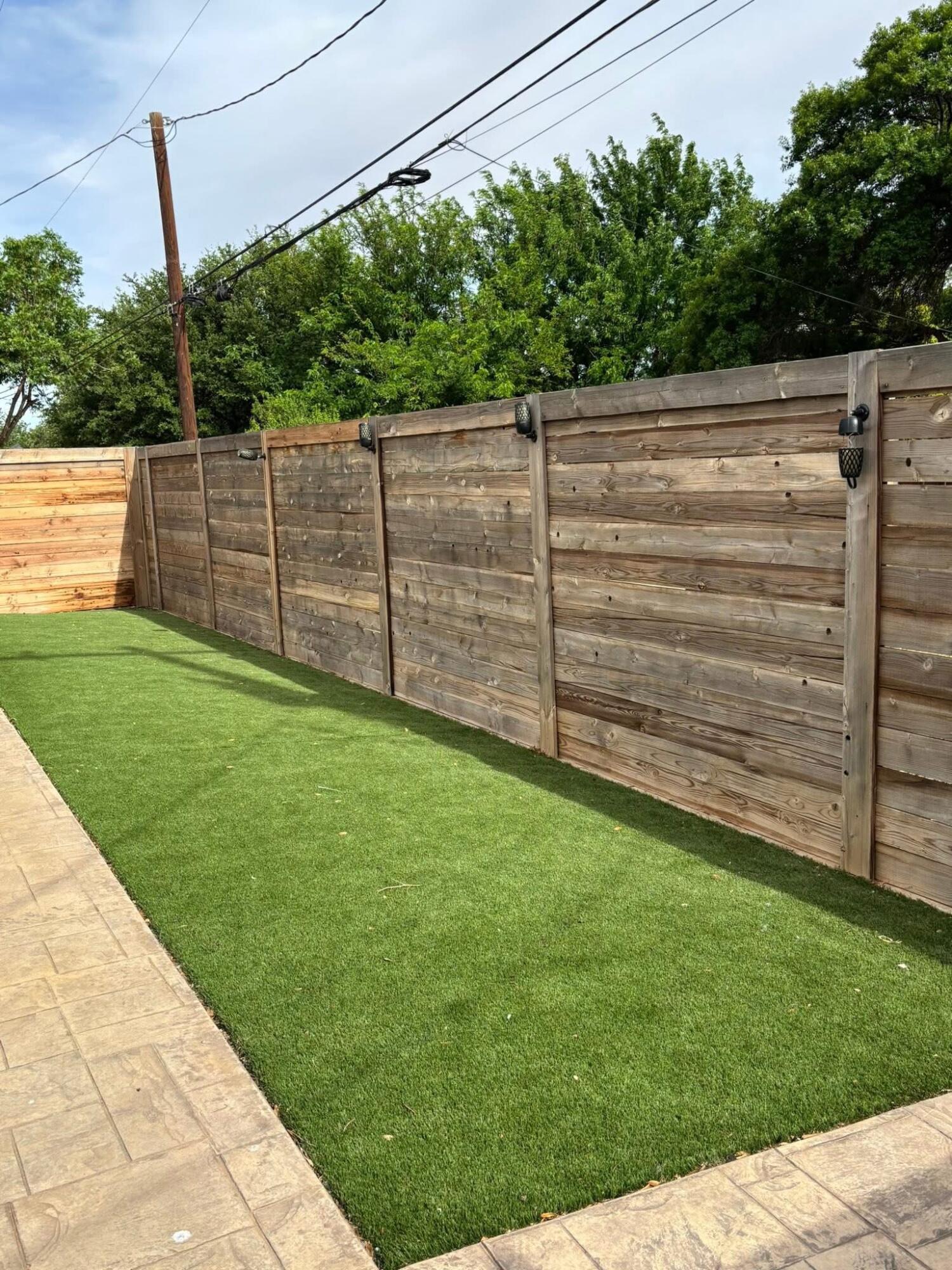 1402 9th Street Shallowater, TX 79363 - Photo 46 of 49 a view of a backyard with a wooden fence