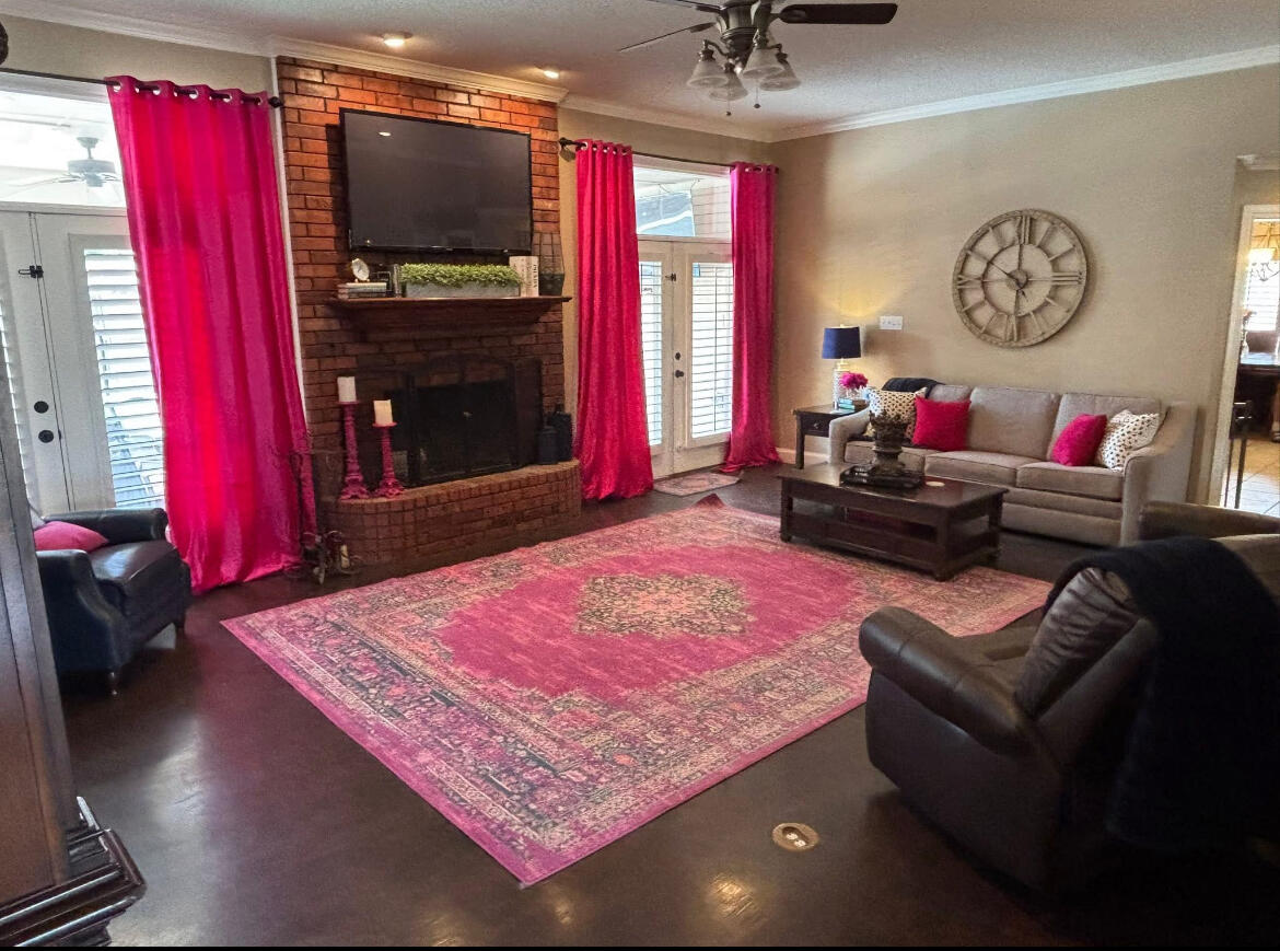 1402 9th Street Shallowater, TX 79363 - Photo 6 of 49 a living room with furniture a rug and a flat screen tv
