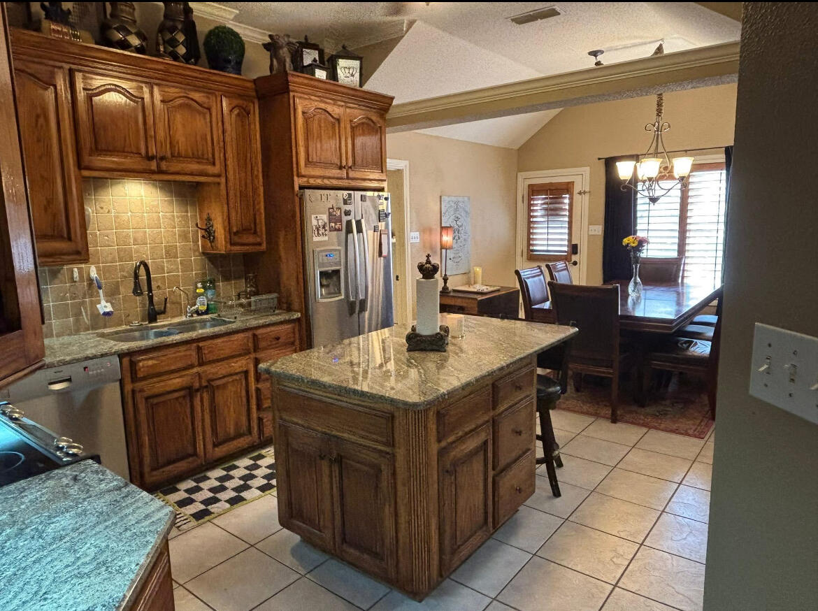 1402 9th Street Shallowater, TX 79363 - Photo 8 of 49 a kitchen with a stove top oven sink and cabinets