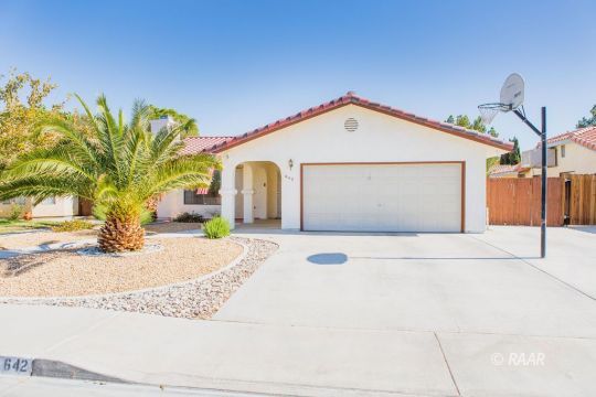 642 Regency Court Ridgecrest, CA 93555 - Photo 2 of 33 a view of a house with a yard and garage
