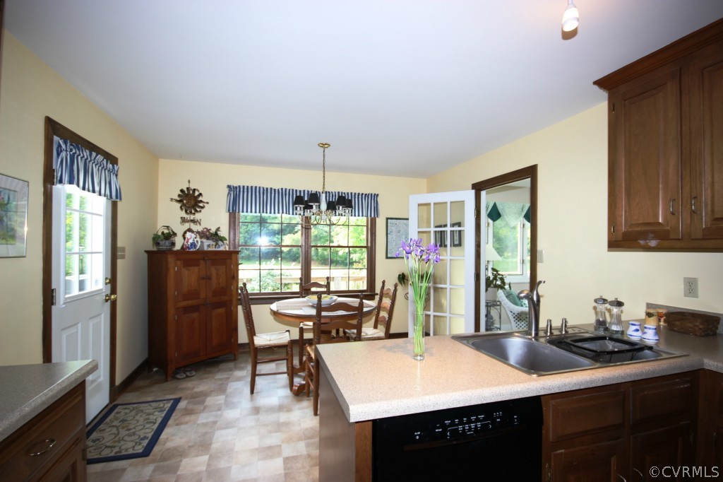 5200 Copperpenny Road Chesterfield, VA 23832 - Photo 4 of 24 a kitchen with a table chairs refrigerator and cabinets