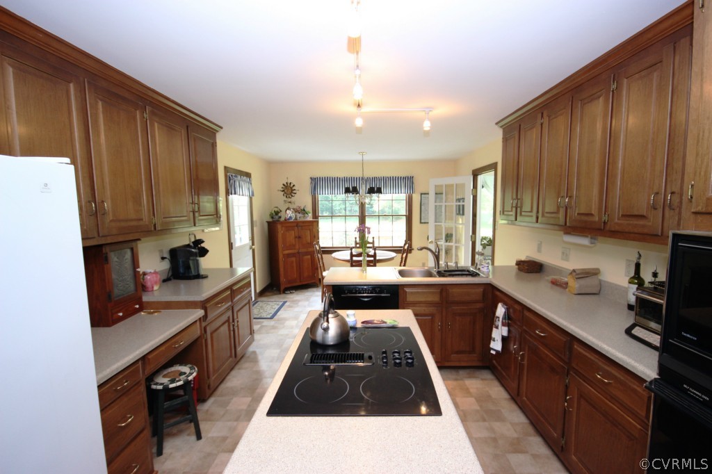 5200 Copperpenny Road Chesterfield, VA 23832 - Photo 5 of 24 a kitchen with kitchen island granite countertop a sink stove and refrigerator